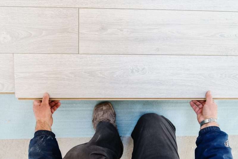 Professional flooring installation - laying a new laminate with a wooden pattern high angle view